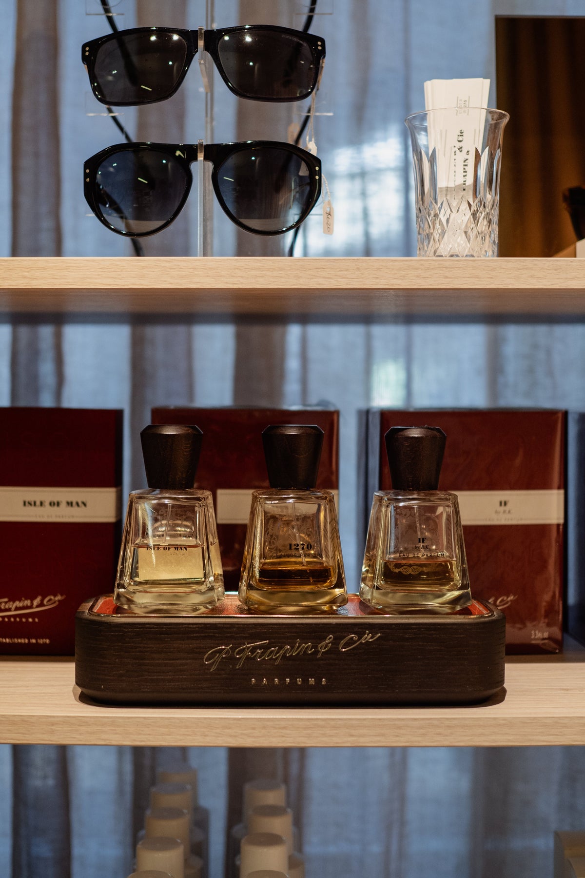 Sunglasses on the shelf above the fragrance flight at Amelie & Frank's in Red Hill