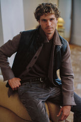 Vintage brown corduroy trousers styled with a brown jacket, seated
