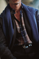 Close view of the Bronte linen check shirt under a dark jacket and scarf