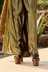 Leone trousers falling to platform sandals, the lurex shimmering olive and gold