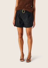Mos The Label Carmelita Shorts in black, worn by model, close view of pleats and belt