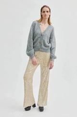 Second Female Shine On Trousers in sequin, flared leg, worn by model with a grey cardigan
