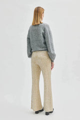 Second Female Shine On Trousers in sequin, worn by model with a grey cardigan, back view