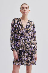 Second Female Cast Printed Dress in black with blurred floral print, worn by model, front view