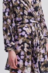 Second Female Cast Printed Dress in black, close view of the blurred print and wrap waist