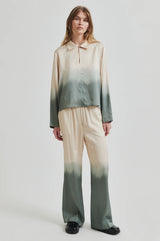 Second Female Avora Dip Dye Pants in agave green, worn by model with matching blouse, front view