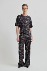 Second Female Savani Trousers in dark animal print, worn by model with matching tee, front view