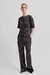Second Female Savani Trousers in dark animal print, worn by model, hand in pocket