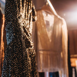 Sabina Musáyev Devon Dress in black metallic, hanging on a rail in soft light