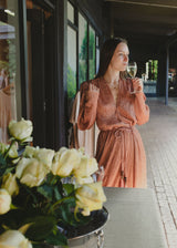 Sabina Musáyev Marble Dress, worn by model on a terrace beside white roses