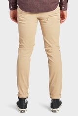 The Academy Brand Cooper Slim Chino in sandstone, worn by model, cropped back view