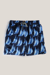 Christian Kimber Rose Bay Swim Shorts in sailing print, navy with blue sailboats, laid flat, studio shot