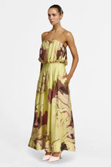 Model with a hand in the side pocket of the full-length Hodel skirt, three-quarter view