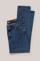 Christian Kimber Rose Street Selvedge Jeans in mid indigo, folded flat showing the front, studio shot