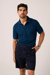 Christian Kimber Rosebud Short Sleeve Polo in navy, worn by model with navy shorts, front view