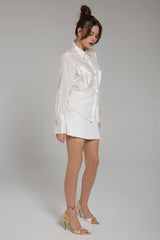 Realm Origin Lustre Shirt in monochrome stripe, worn by model with a white mini skirt, three-quarter view