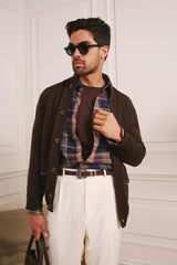 Bronte linen check shirt worn under a dark jacket with cream trousers