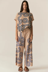 POL Alter Top in tan with navy swirl print, worn by model with matching pant, front view