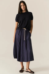 POL Pax Pocket Tee in ink, worn by model with a navy drawstring skirt, front view