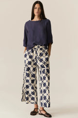 POL Henri Tee in ink, worn by model with navy and cream print wide-leg pants, front view