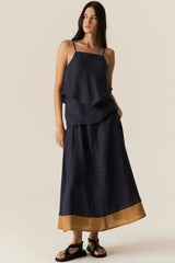 POL Speck Cami in ink, layered hem cami worn by model with a navy skirt, front view