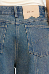 Acler Otham Jean in vintage wash denim, close-up of back pocket and Acler patch