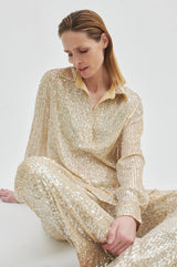 Second Female Shine On Trousers in sequin, worn seated by model with a matching shirt