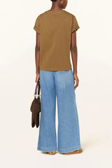 Back view of the caramel brown tee with wide light jeans