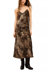 Brown animal print midi slip dress with chain straps, worn with black boots, full length front view
