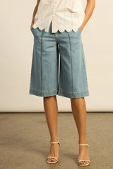 Zoe Kratzmann Compass Short in light washed denim, knee length, worn by model, front view