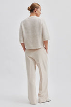 Second Female Andrea Knit Rib Cardigan in pumice stone, worn by model, back view