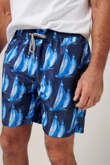 Christian Kimber Rose Bay Swim Shorts in sailing print, on figure with a white T-shirt, front view