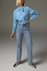 Zoe Kratzmann Society Jean in washed denim, worn by model with a blue blouse, full length