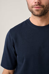 Christian Kimber Apollo T-Shirt in navy, close view of the crew neck and sleeve on figure