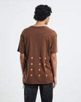 Ksubi 4x4 Biggie Tee in brown, worn by model, back view of orange cross print