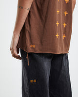 Ksubi 4x4 Biggie Tee in brown, close detail of the orange cross print and raw hem