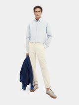 Scotch & Soda Stuart Twill Chino in kit, worn by model holding a navy jacket, full length