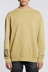 Ksubi Crowded Kash Crew in khaki, worn by model, front view with sleeve print