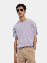 Scotch & Soda Tee in lilac with chest pocket, worn by model with printed shorts, front view