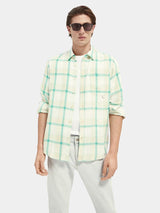 Scotch & Soda Tencel Check Shirt in green, worn open by model with light jeans, front view