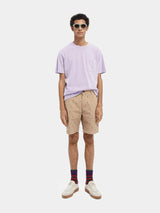 Scotch & Soda Tee in lilac, worn by model with beige shorts, full length