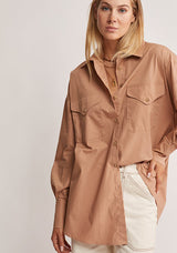 Mos The Label Wanderer Blouse in dusty clay, worn by model, close front view of pockets and buttons