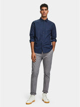 Scotch & Soda Palette Bleu Shirt in navy, worn by model with grey trousers and white sneakers, full length