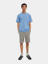 Scotch & Soda Classic Crewneck in cornflower blue, worn by model with grey shorts, full length