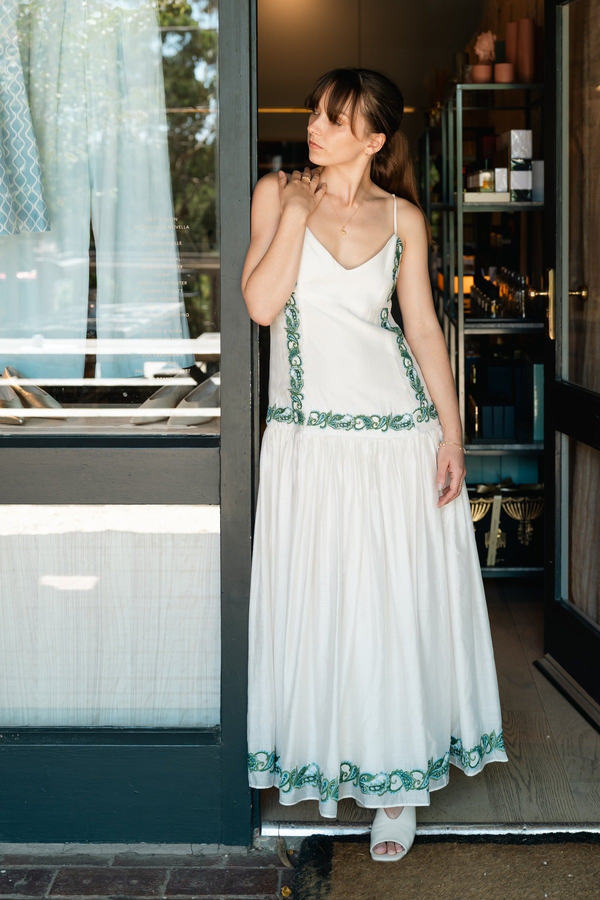 The Porto embroidery dress by MOS The Label, worn in the doorway of the Amelie & Frank's boutique at Red Hill