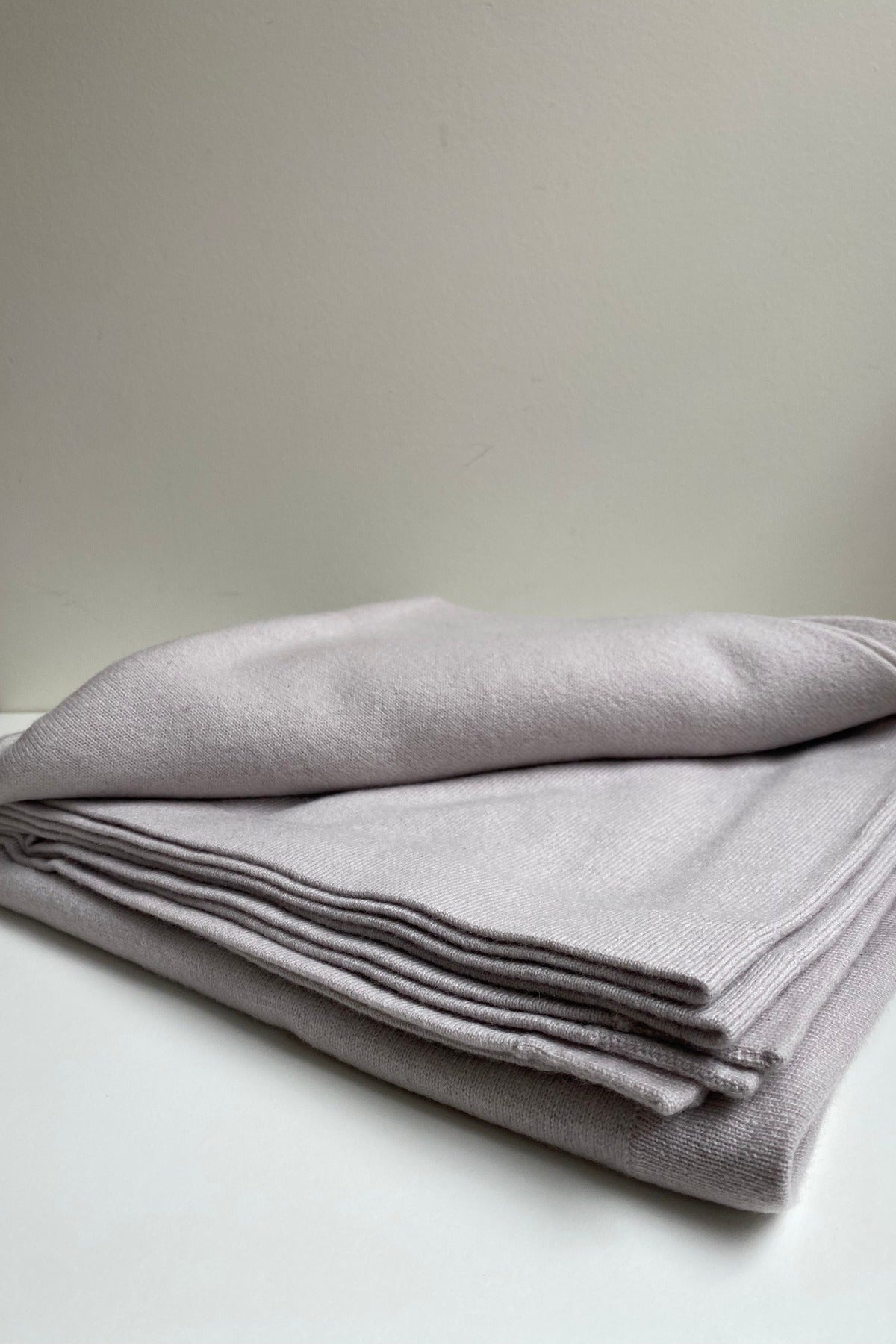 Amelie & Frank's hand-combed Inner Mongolian cashmere throws folded in oatmeal and grey