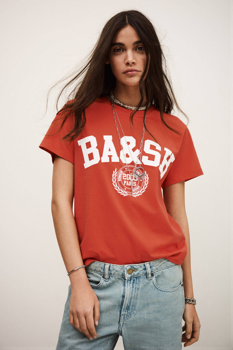 ba&sh Ioni Tee in rouge, red varsity print tee worn by model with light jeans, front view