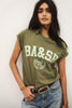 Olive kaki tee with a mint BA&SH 2003 Paris varsity print, worn with light jeans and a brown belt
