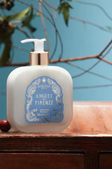 Santa Maria Novella Angeli di Firenze Fluid Body Cream, pump bottle beside a white bust, still life
