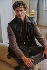 Christian Kimber Quilted Lambskin Vest worn by model seated over a brown overshirt, lifestyle shot indoors